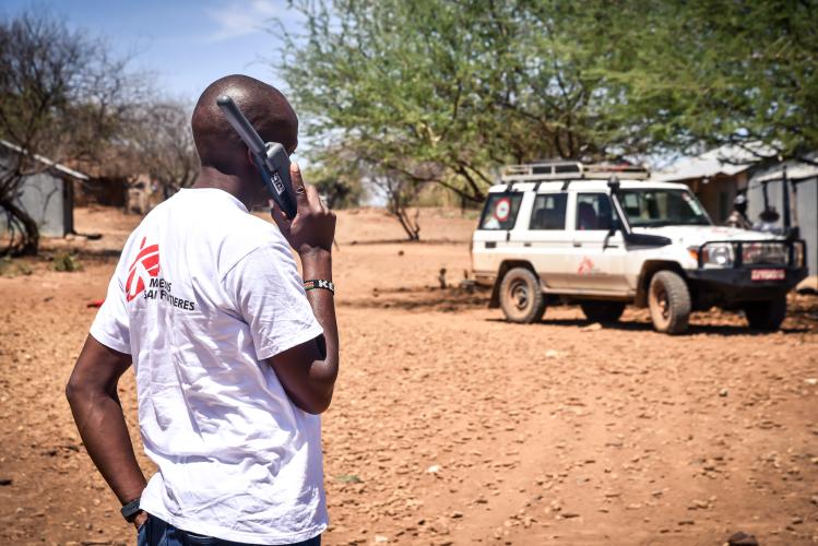 An MSF staff uses a satellite phone to make a call in Tiaty, Baringo County